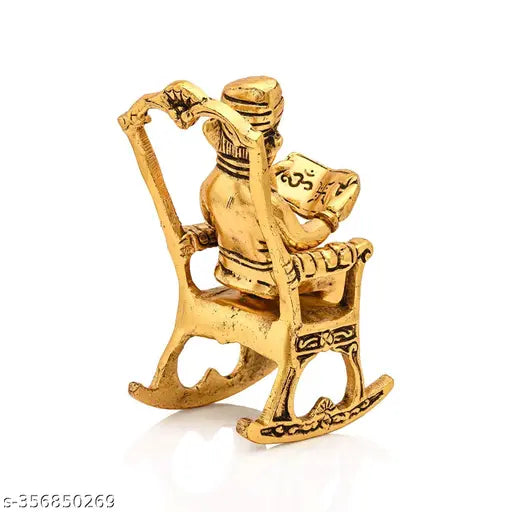 Antique golden brass Ganesha statue, seated on a chair reading a book. Handcrafted Indian Ganesh idol