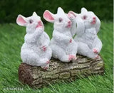 Three rabbit figurines on a tree trunk table top, faux fur detailing, 4.5 inches tall, living room decoration