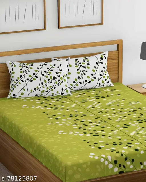 Green and white bedspread with black leaves design