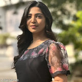 A woman in a floral print sleeveless top with a V-neckline