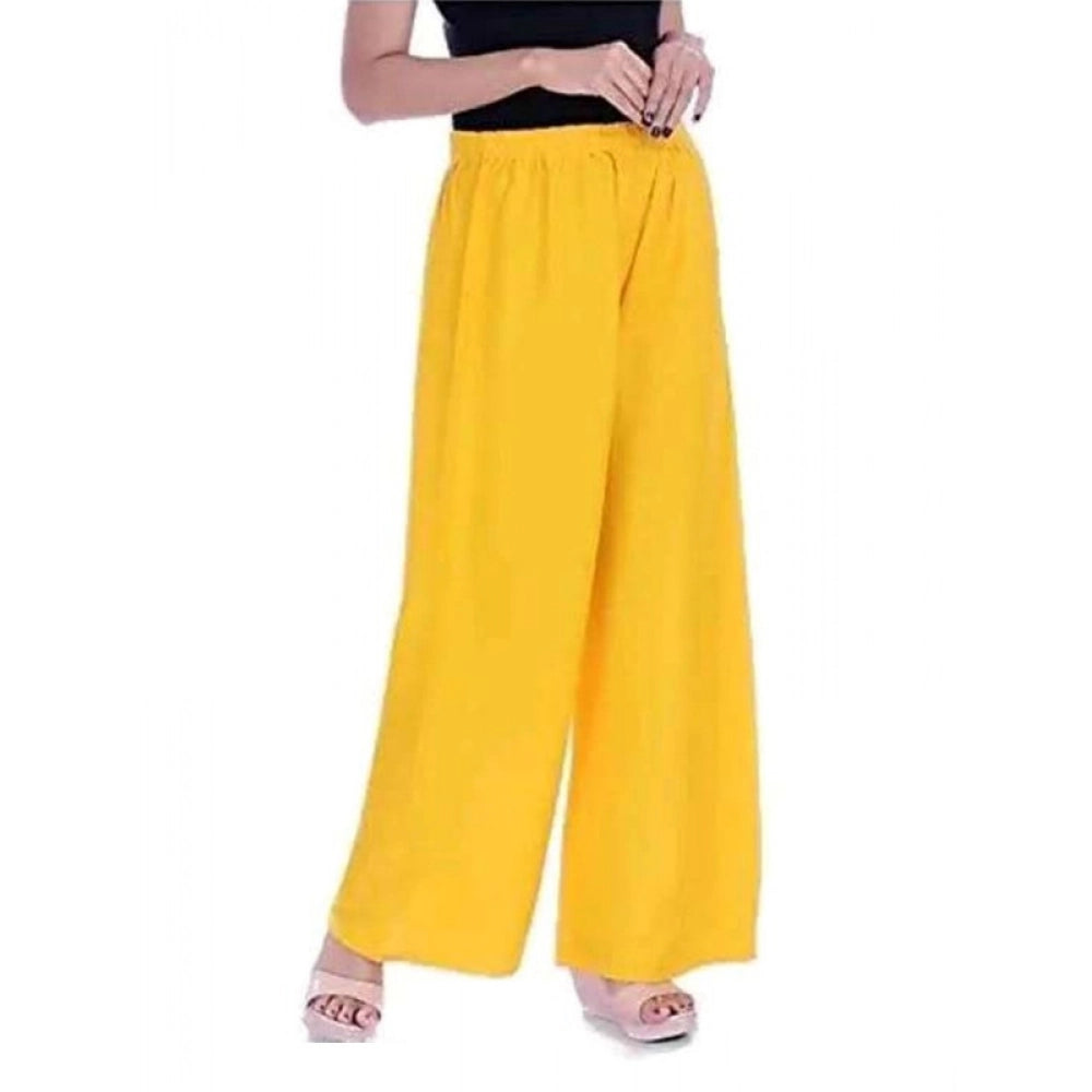 Yellow rayon casual ankle-length palazzo for women, free size, solid pattern on display