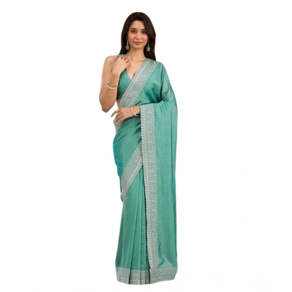 Light green silk embroidered saree with unstitched blouse, intricate patterns showcased on a model
