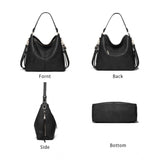 Black PU leather zipper handbag for women, medium size on table
