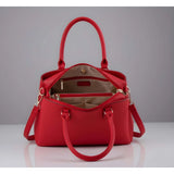 Red PU Leather Solid Handbag with 3 compartments, adjustable strap, and zipper closure