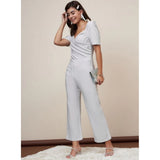 Silver polyester shimmer self-design jumpsuit for women, features sweatheart neck, zip closure, ankle length pant style