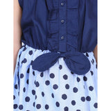 Blue denim polka sleeveless dress with round neck and button closure on model, cotton lining for comfort