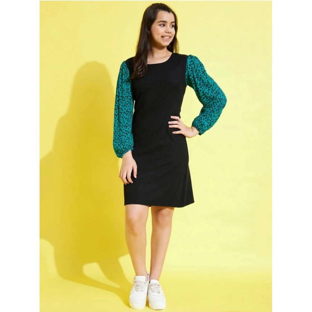 Black-Green printed polyester long sleeves girl's dress on hanger, vibrant pattern details visible