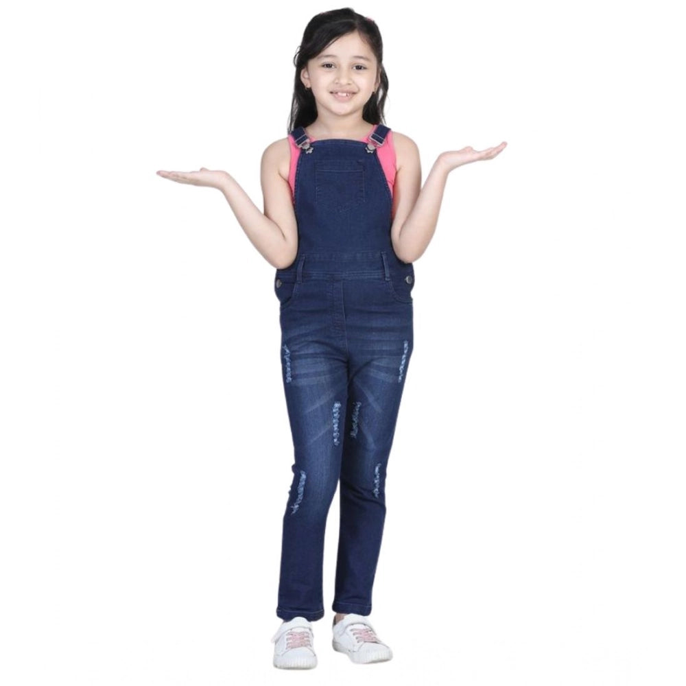 Blue denim distressed buttoned dungaree for girls, casual wear on model