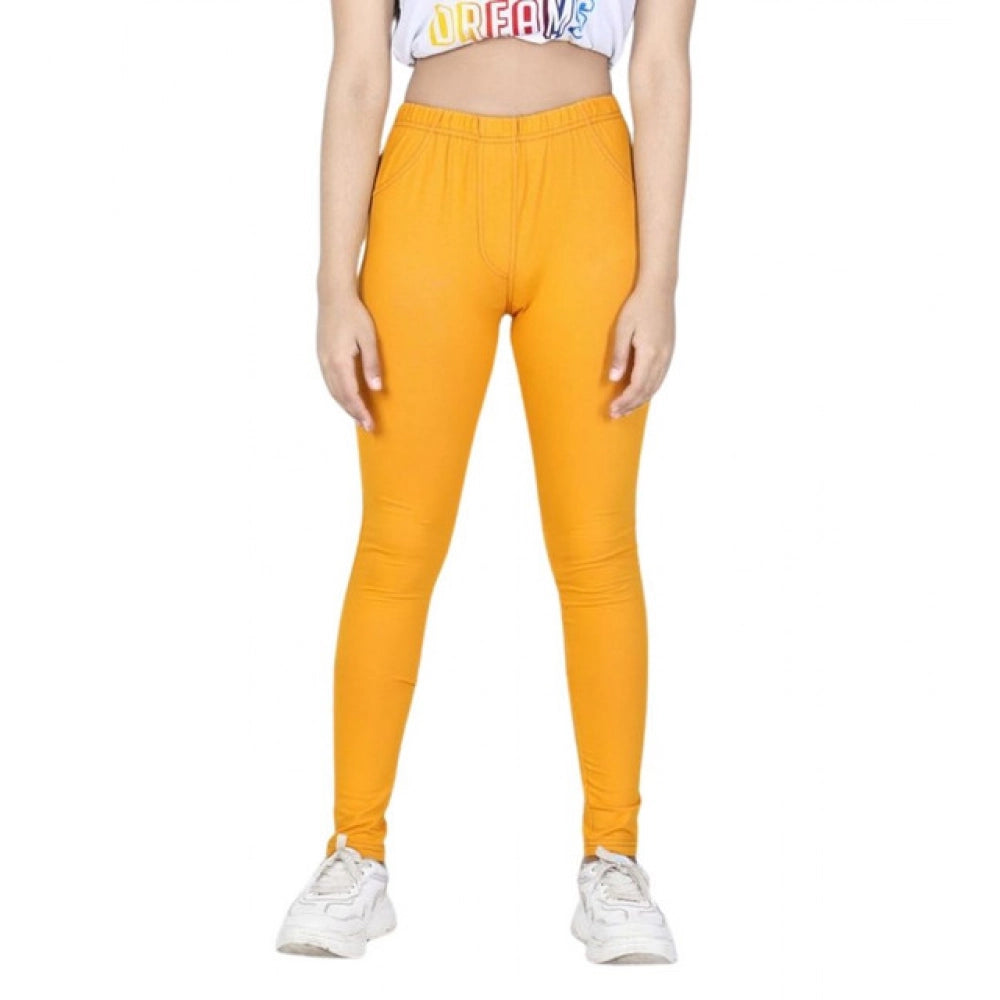 Mustard cotton lycra elasticated jeggings for girls, solid pattern on display
