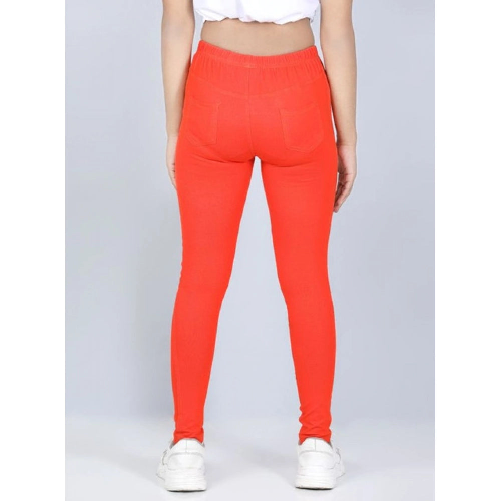 Orange cotton lycra elasticated jeggings for girls, solid pattern with slight variation in color compared to images