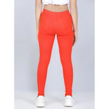 Orange cotton lycra elasticated jeggings for girls, solid pattern with slight variation in color compared to images