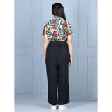 Multi-colored black polyester printed short sleeves girls' jumpsuit, vibrant design on display stand