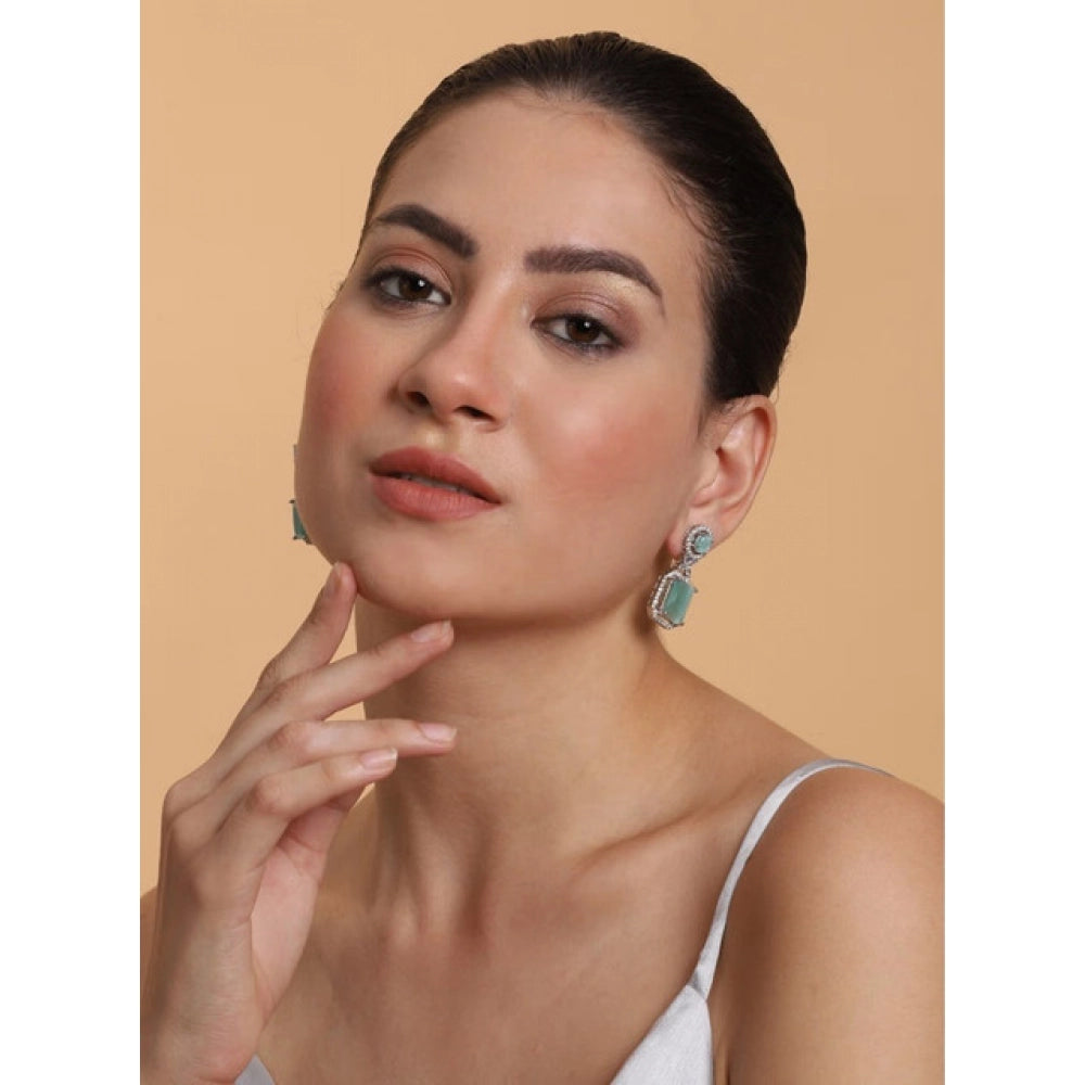 Women's brass silver plated turquoise drop earrings, delicate jewelry on display