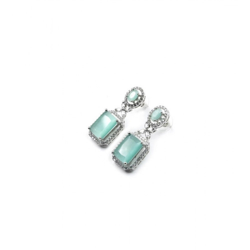 Women's turquoise brass silver plated drop earrings, elegant jewelry accessory on display stand