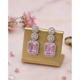 Women's pink brass silver plated drop earrings, stylish jewelry accessory on display