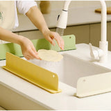 { "alt_text": "Multicolor silicone sink splash guard for kitchen counter, waterproof anti-splash protection, suction cup drain cover" }