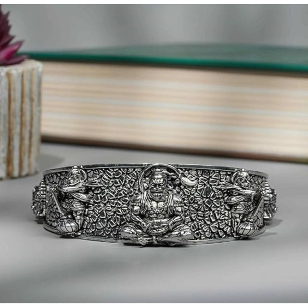 { "alt_text": "Silver metal half wrist kada for Lord Hanuman devotees, spiritual protection jewelry, inner strength accessory" }