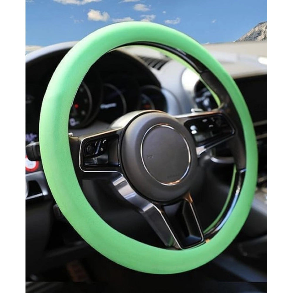 { "alt_text": "Green silicone universal steering wheel cover for car, anti-slip grip automotive accessory, superior protection" }