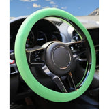{ "alt_text": "Green silicone universal steering wheel cover for car, anti-slip grip automotive accessory, superior protection" }