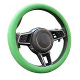 { "alt_text": "Green silicone universal steering wheel cover for car, anti-slip grip automotive accessory, superior protection" }