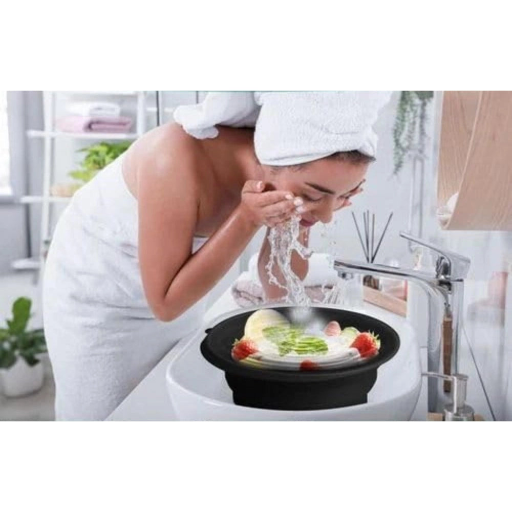 { "alt_text": "Black silicone facial ice bowl for pore tightening, puffiness relief, and post-workout recovery on travel kit" }