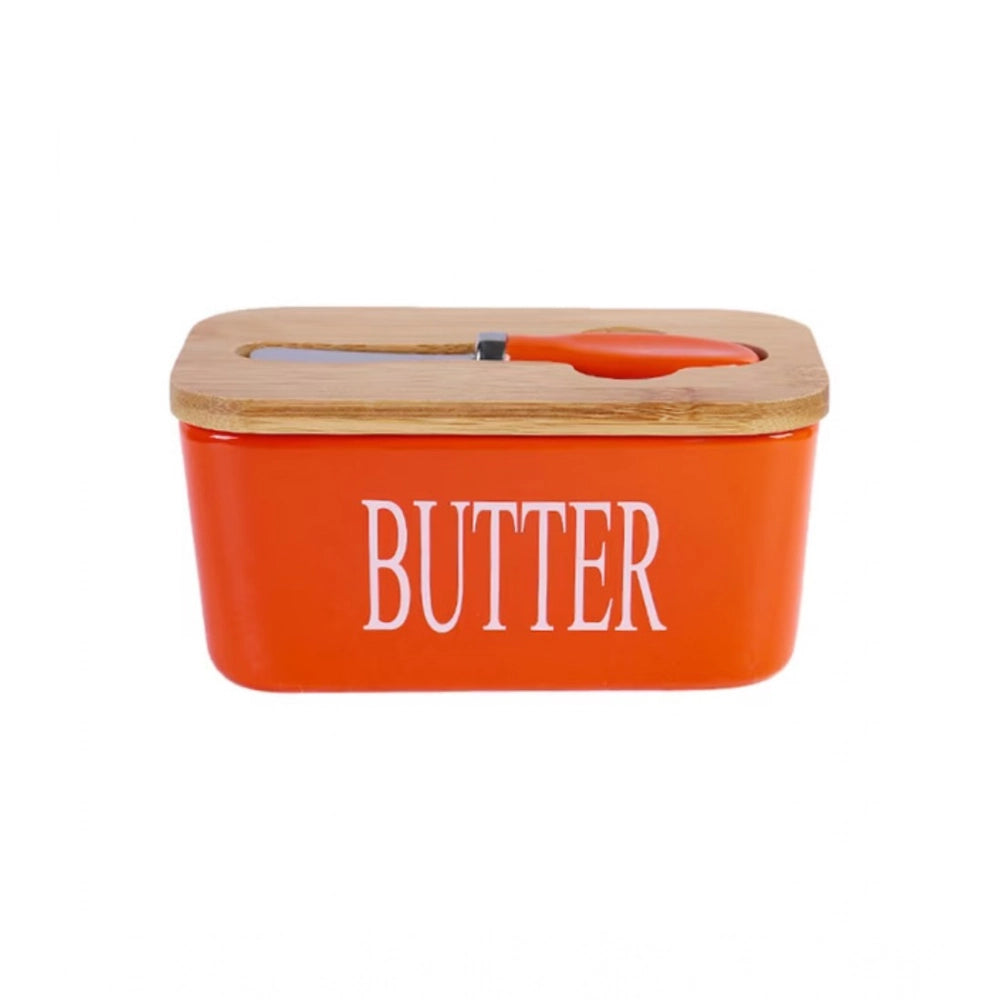 { "alt_text": "Orange ceramic butter box with bamboo lid, airtight storage container for fresh butter, kitchen countertop accessory" }