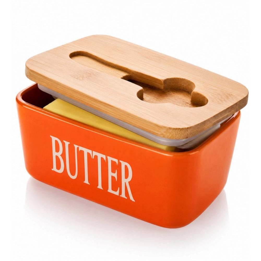{ "alt_text": "Orange ceramic butter box with bamboo lid, airtight storage container for fresh butter, kitchen countertop accessory" }