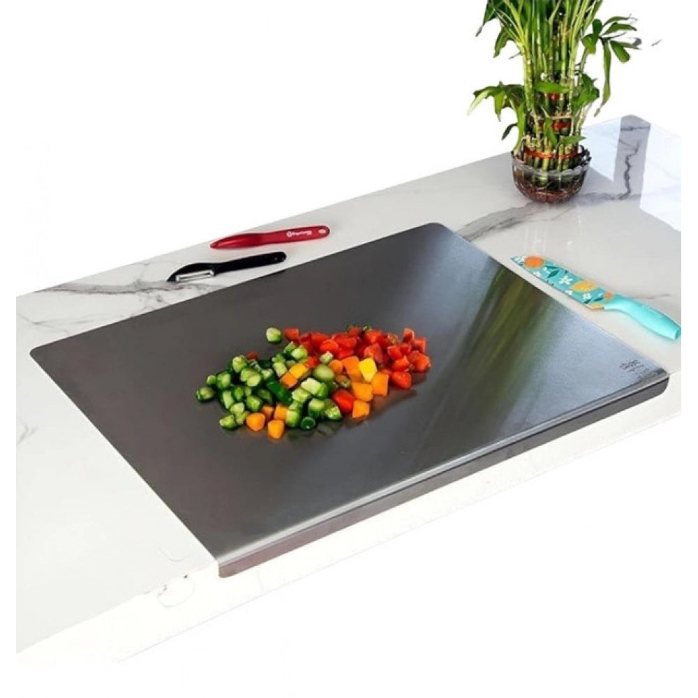 { "alt_text": "Silver stainless steel chopping board for kitchen prep, durable food preparation tool with built-in lip" }