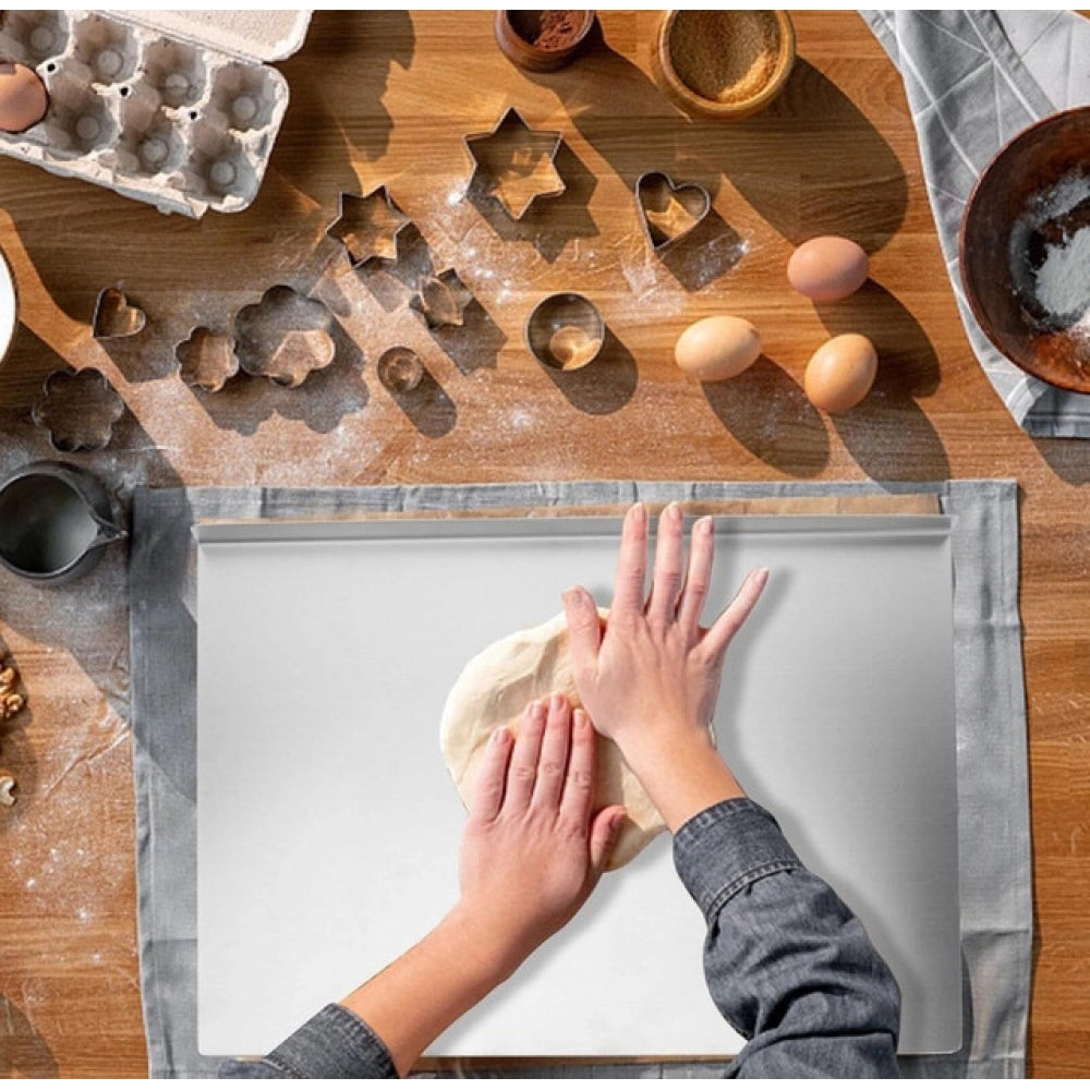 { "alt_text": "Silver stainless steel chopping board for kitchen prep, durable food preparation tool with built-in lip" }