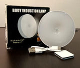 White motion sensor LED light with magnetic attachment for hands-free illumination in dark areas