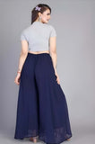 { "alt_text": "Navy blue georgette women's palazzo pants, solid high-rise wide leg flared trousers, ankle length ethnic wear" }