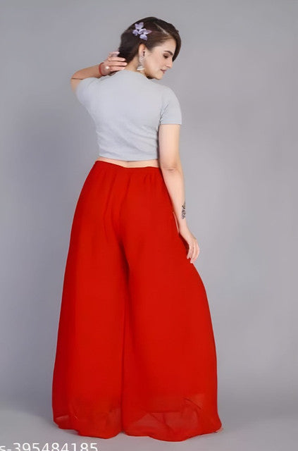 { "alt_text": "Red georgette women's palazzo pants, solid high-rise wide leg flared pants, ankle length ethnic wear" }