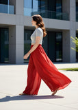 { "alt_text": "Red georgette women's palazzo pants, solid high-rise wide leg flared palazzo, ankle length elastic waist" }