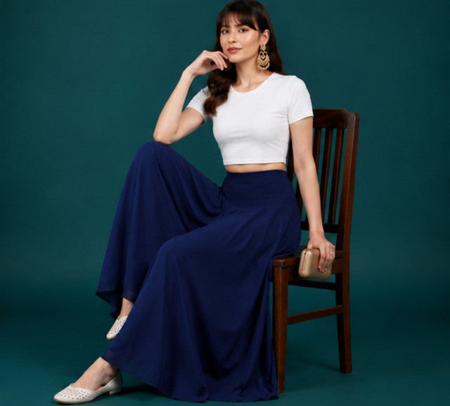 { "alt_text": "Navy blue georgette women's palazzo pants, solid mid-rise wide leg flared pants, ankle length ethnic wear" }
