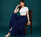 { "alt_text": "Navy blue georgette women's palazzo pants, solid mid-rise wide leg flared pants, ankle length ethnic wear" }