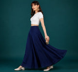 { "alt_text": "Navy blue georgette women's palazzo pants, solid mid-rise wide leg flared pants, ankle length ethnic wear" }