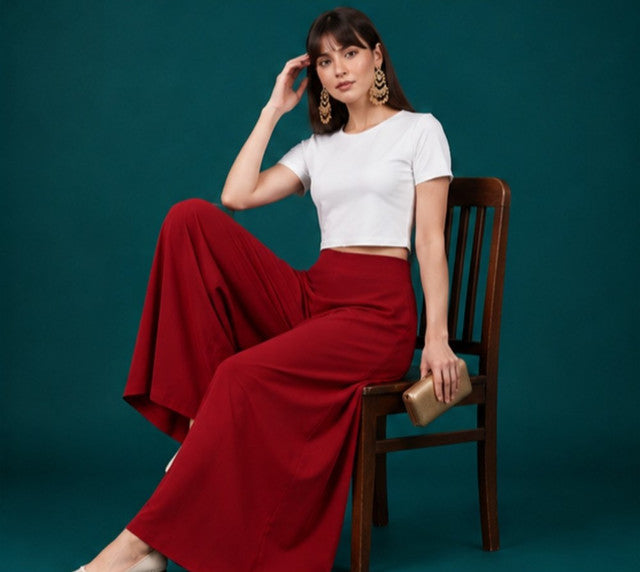 { "alt_text": "Maroon georgette women's palazzo pants, solid wide leg flared pants, mid-rise elastic waist ankle length" }