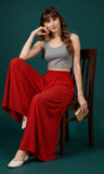 { "alt_text": "Red georgette women's palazzo pants, solid mid-rise wide leg flared pants, ankle length ethnic wear" }