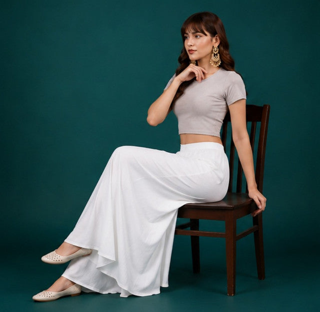 { "alt_text": "White georgette women's palazzo pants, solid mid-rise wide leg flared pants, ankle length ethnic wear" }