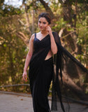 { "alt_text": "Black georgette solid saree with unstitched blouse 5.5Mtr, elegant ethnic wear for women" }