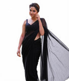 { "alt_text": "Black georgette solid saree with unstitched blouse 5.5Mtr, elegant ethnic wear for women" }