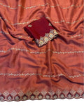 { "alt_text": "Rust orange georgette embroidered saree with unstitched blouse, 5.5 meter ethnic wear, Indian fashion" }