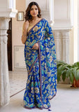 { "alt_text": "Blue georgette saree floral printed women's ethnic wear, 5.5mtr georgette saree with unstitched blouse" }