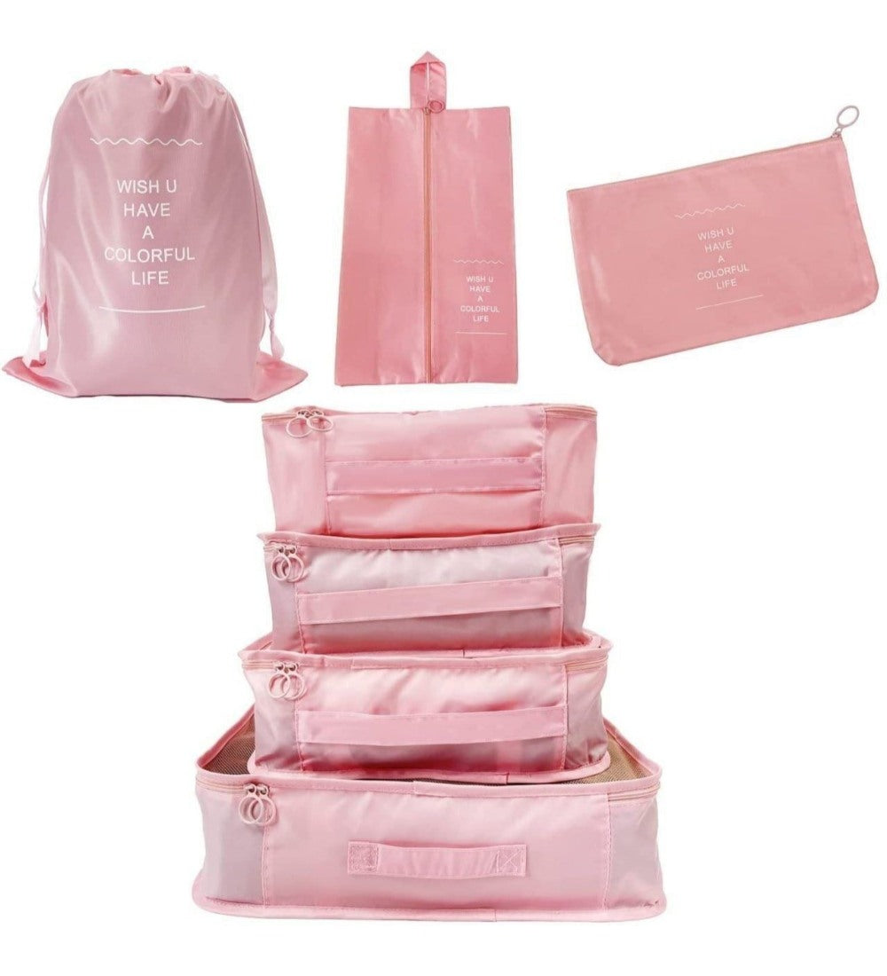 Pink nylon 7-piece travel packing cube set with various organizers for clothes, shoes, and toiletries