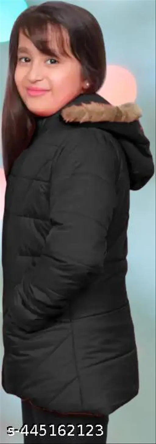 The image shows a young woman posing in a long coat, possibly of black material with a hood