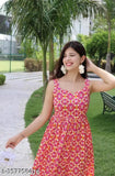 Pink maxi dress with white floral print, cotton, features spaghetti straps and a playful design.