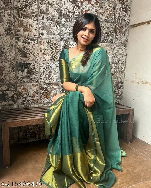 Yellow and green geometric print georgette saree, woman posed against wall