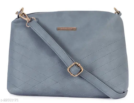 Light blue quilted shoulder bag with a gold buckle