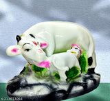 Gopal Kamdhenu figurine, ceramic material, depicts cows and child at home office setting