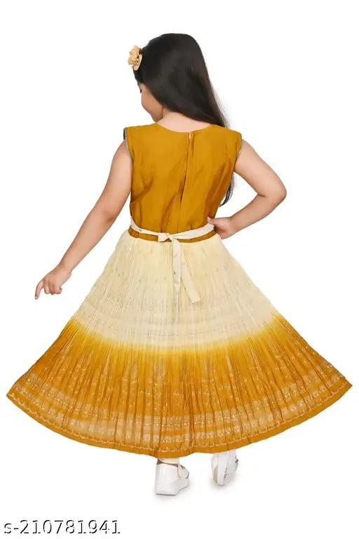A child in a yellow and cream patterned frock